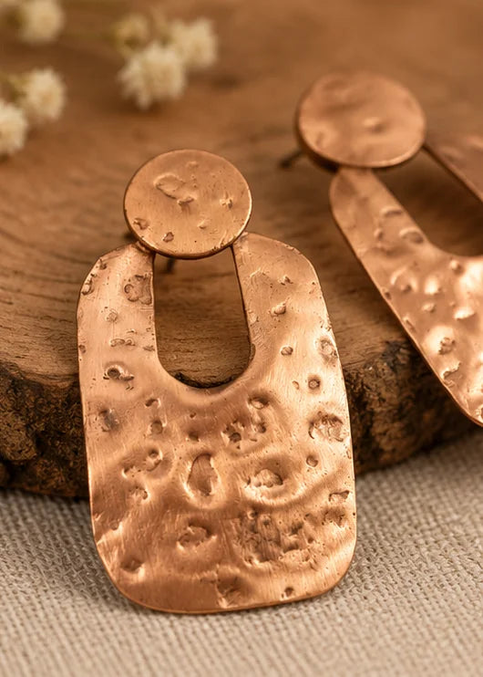 Hammered copper drop earrings for women worn with an elegant outfit
