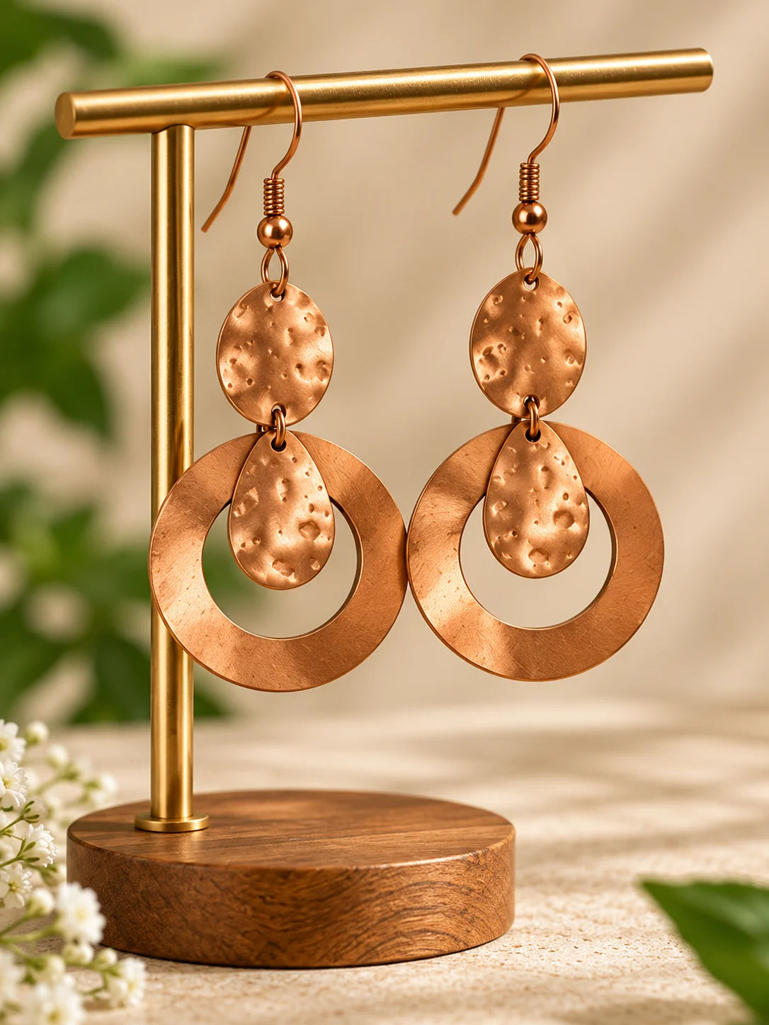 Handmade copper drop earrings showing textured copper finish
