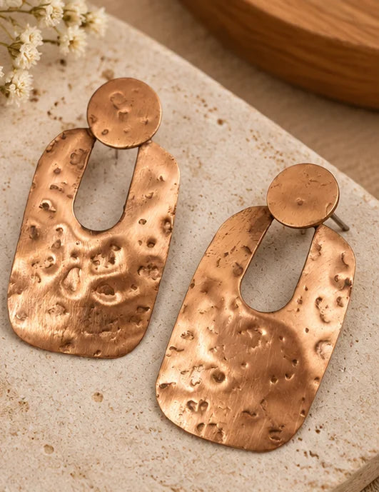 Hammered copper drop earrings featuring a geometric design